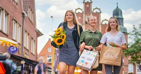 Drei junge Frauen gehen in Meppen shoppen.